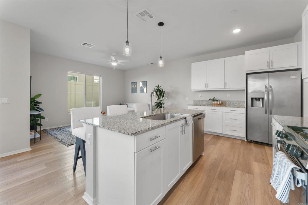 212 Perennial Place Fallbrook, CA 92028 - Photo 8 of 39 a kitchen with a sink stainless steel appliances and cabinets