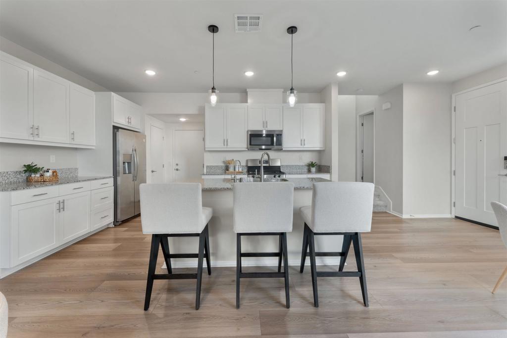 212 Perennial Place Fallbrook, CA 92028 - Photo 9 of 39 a kitchen with kitchen island a table and chairs in it