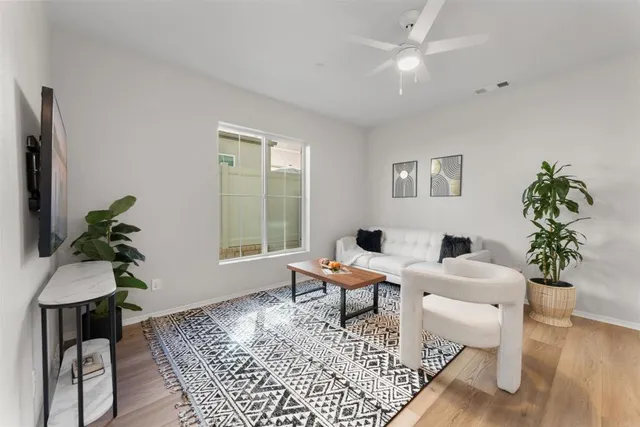 a living room with furniture and a potted plant