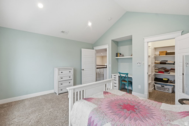 672 Perry Hollow Drive Mapleton, UT 84664 - Photo 56 of 106 Vaulted ceiling bedroom featuring plush carpet, built-in desk with shelving, recessed lighting, and a closet with shelving