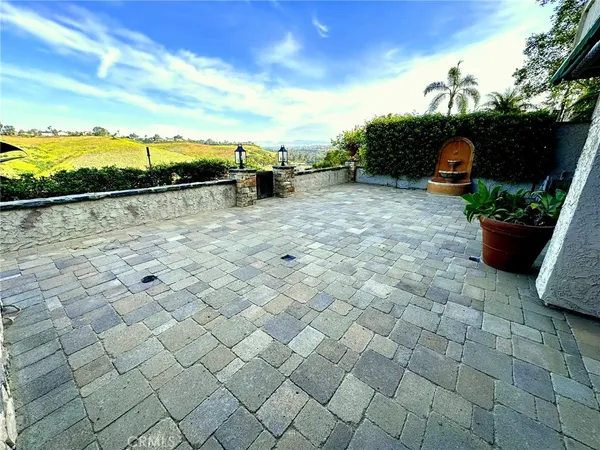 a view of a room with wooden floor and a ceiling fan