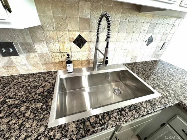 an empty room with wooden floor and entrance