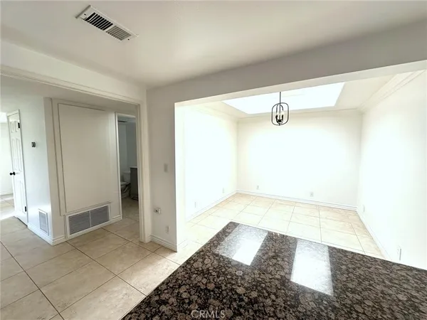 a bathroom with a granite countertop sink a mirror and a shower