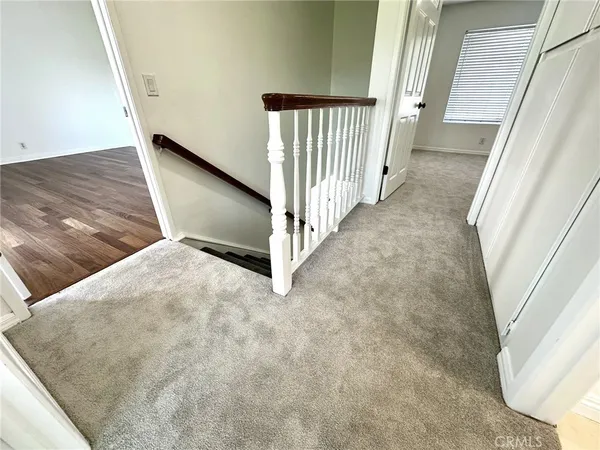 an empty room with windows and stairs