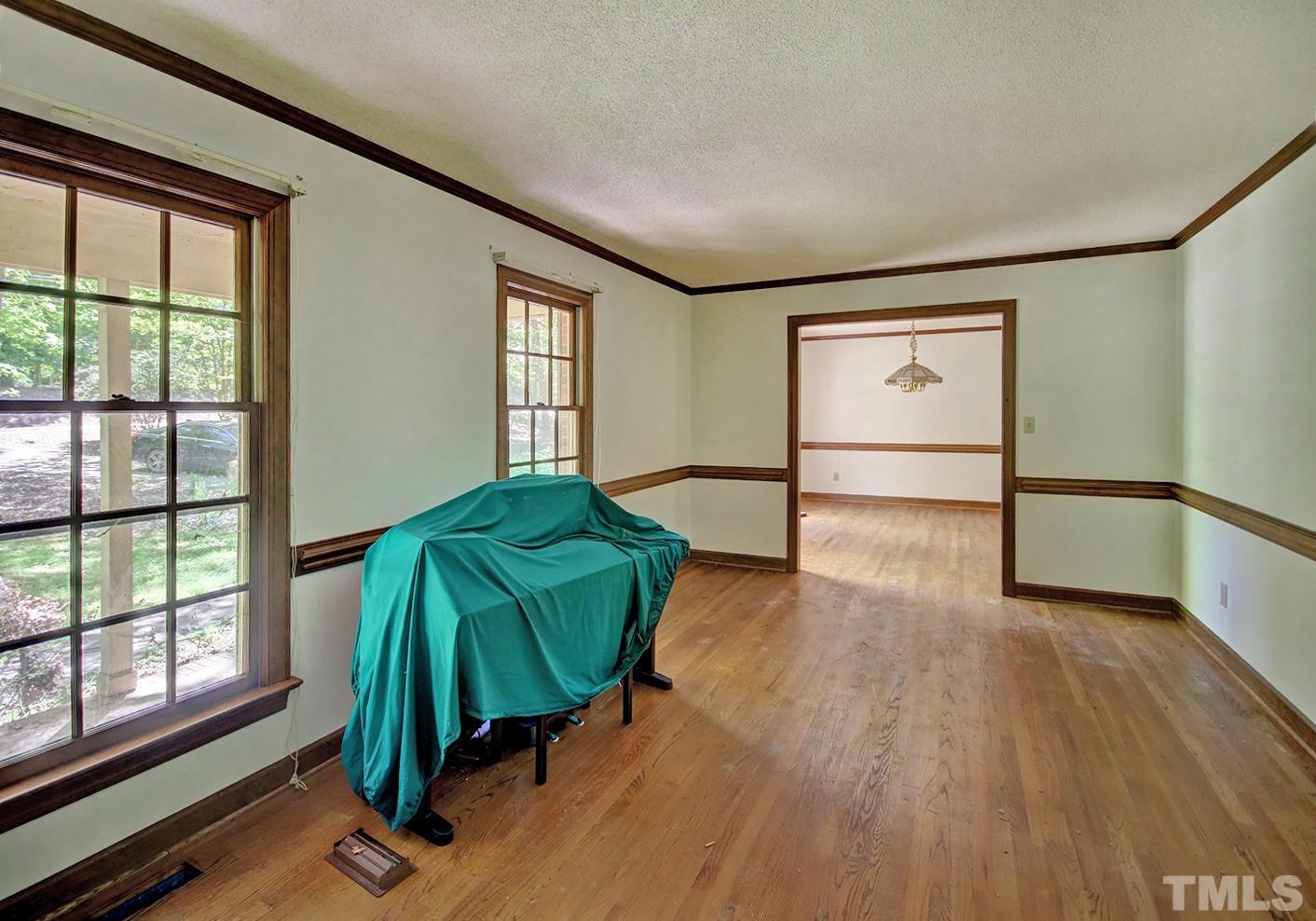 12409 Hardee Road Raleigh, NC 27614 - Photo 7 of 25 a living room with a bed and a window