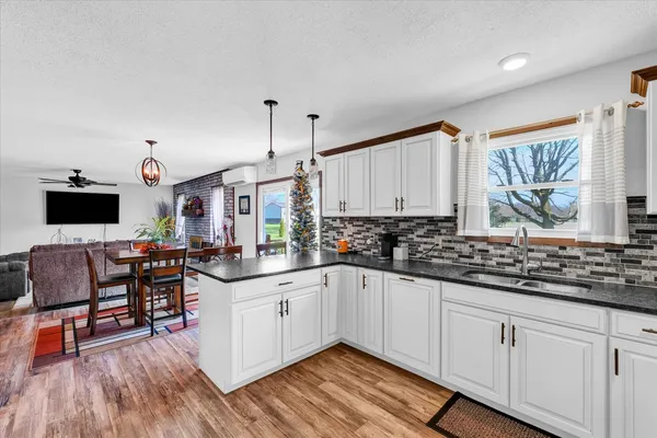 a kitchen with granite countertop a sink and cabinets