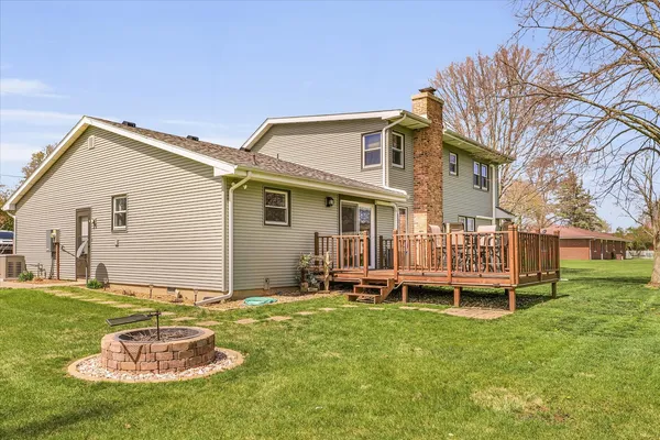 a backyard of a house with table and chairs