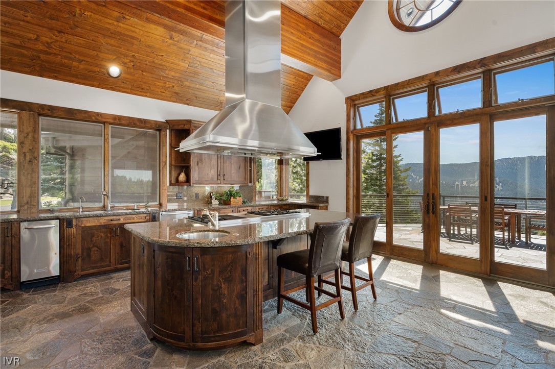 797 Ida Court Incline Village, NV 89451 - Photo 11 of 43 a view of a kitchen with kitchen island a large window a sink and stainless steel appliances