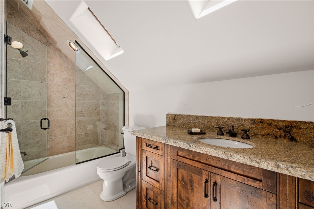 797 Ida Court Incline Village, NV 89451 - Photo 35 of 43 a bathroom with a granite countertop sink a toilet and shower