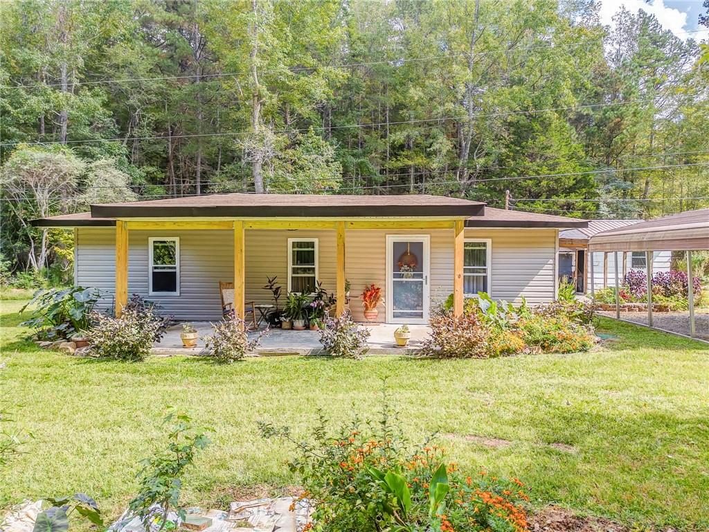 a front view of house with yard and green space
