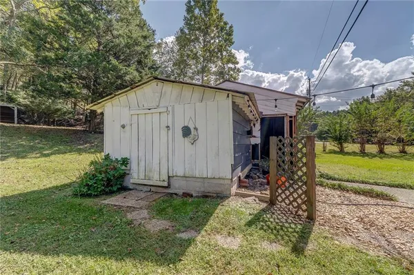 a view of a backyard with a small cabin