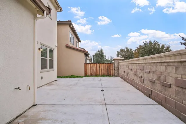 a view of a patio with couches table and chairs and potted plants