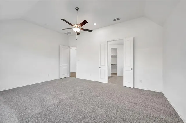 a view of a big room with chandelier fan