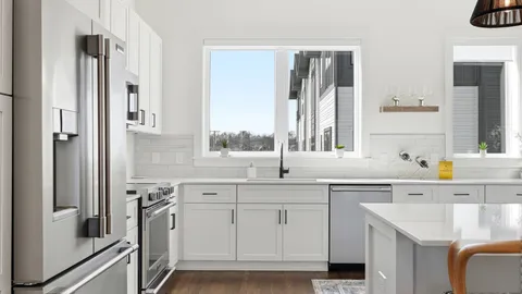 a kitchen with a sink stove and cabinets
