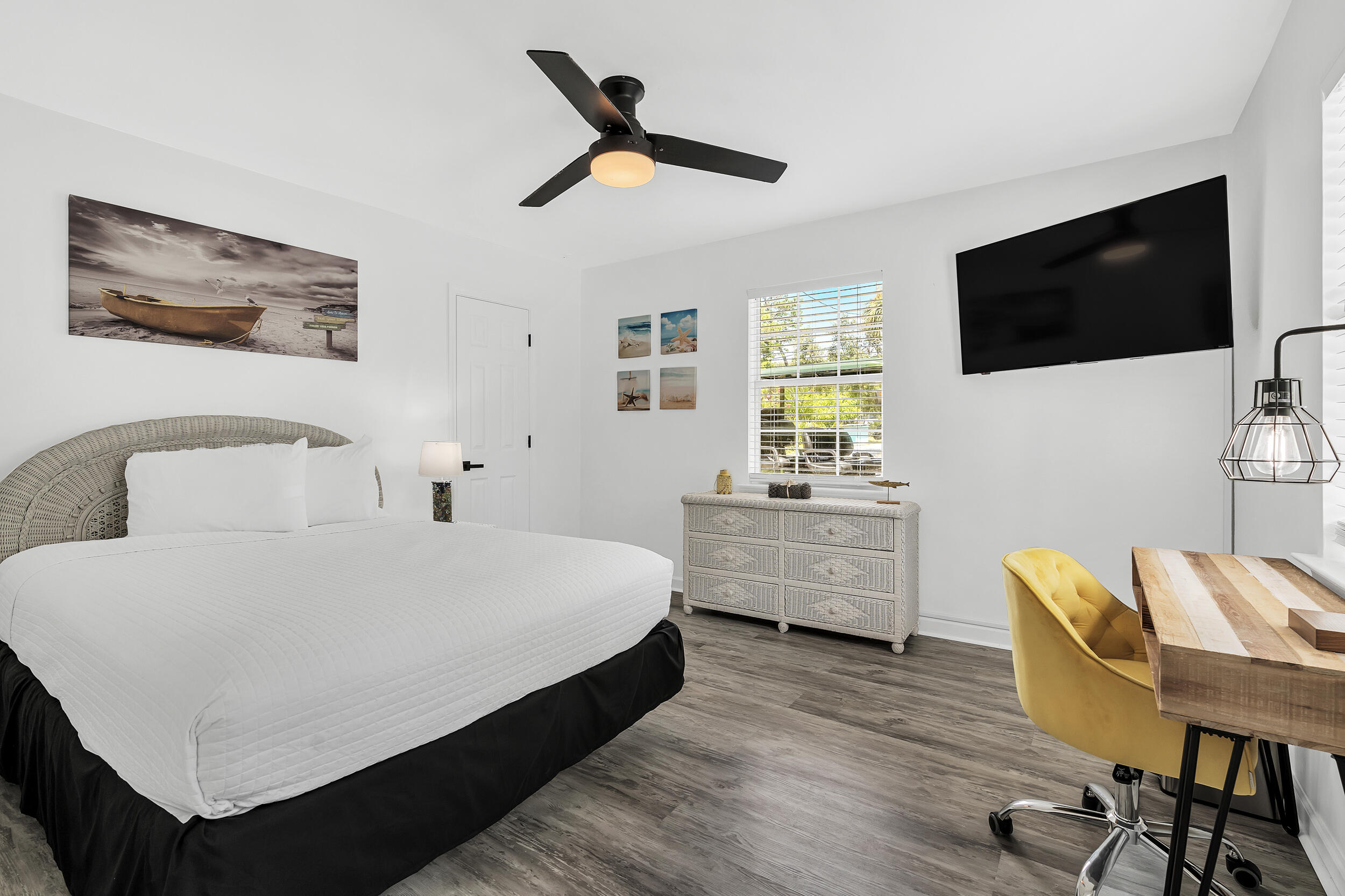 481 North Orange Street Inlet Beach, FL 32461 - Photo 14 of 57 a bedroom with a bed a chair and a flat screen tv