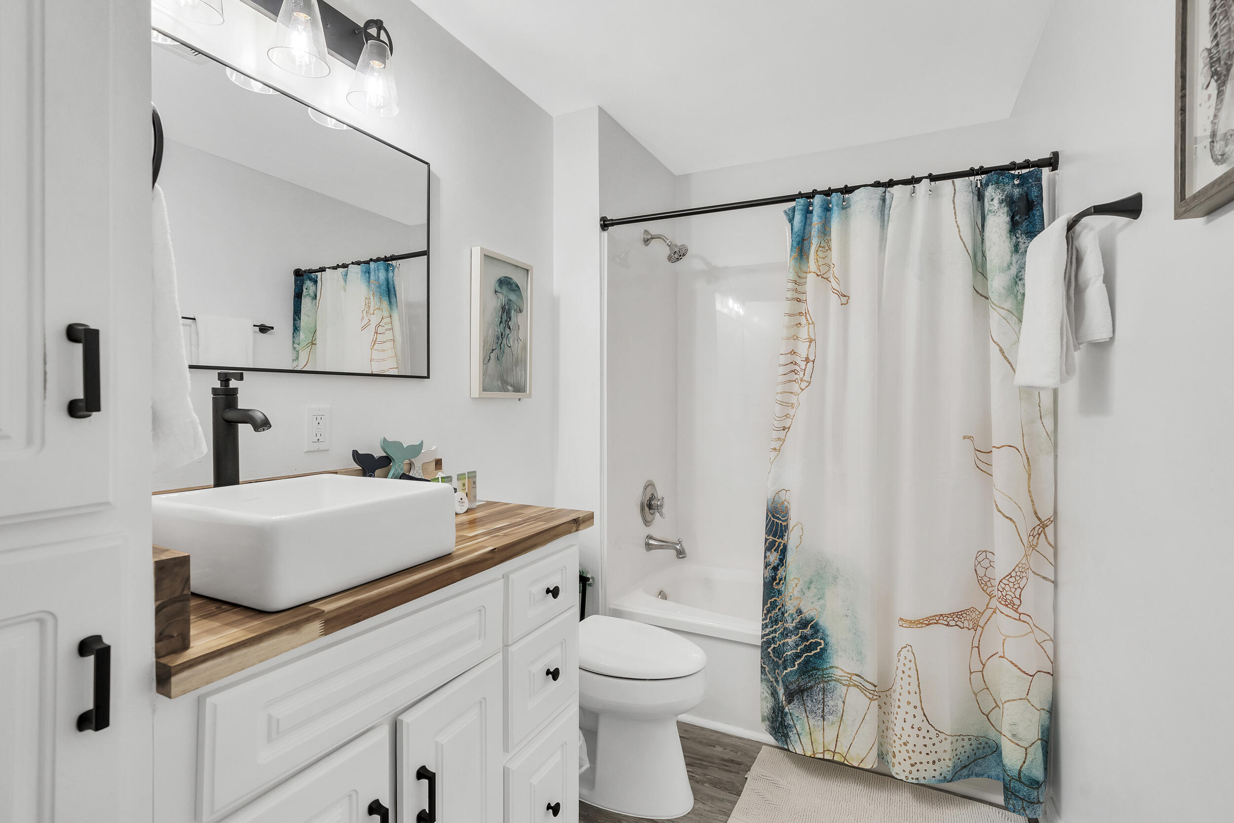 481 North Orange Street Inlet Beach, FL 32461 - Photo 16 of 57 a bathroom with a sink a toilet and shower