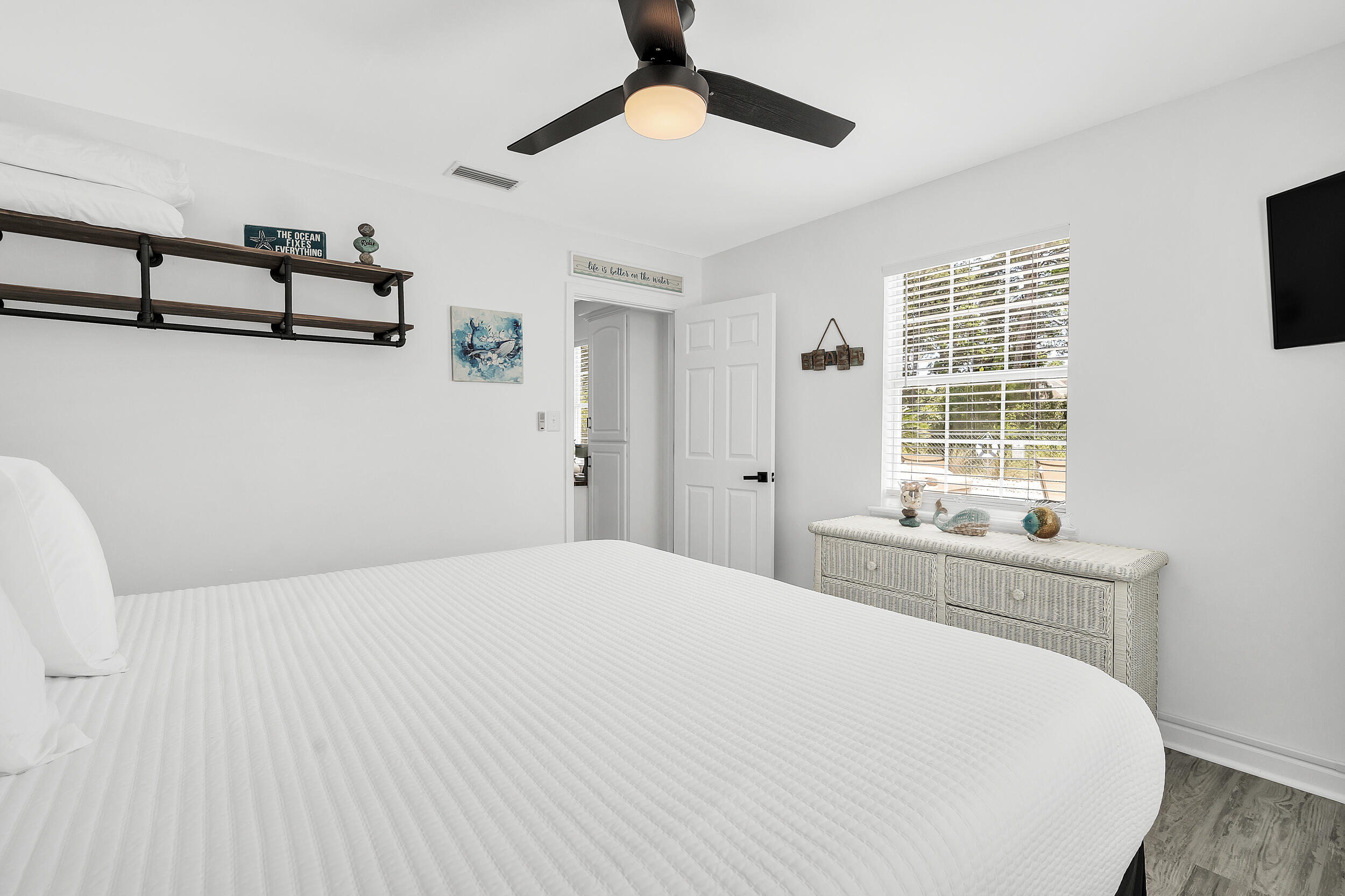481 North Orange Street Inlet Beach, FL 32461 - Photo 18 of 57 a bedroom with a bed and a chandelier
