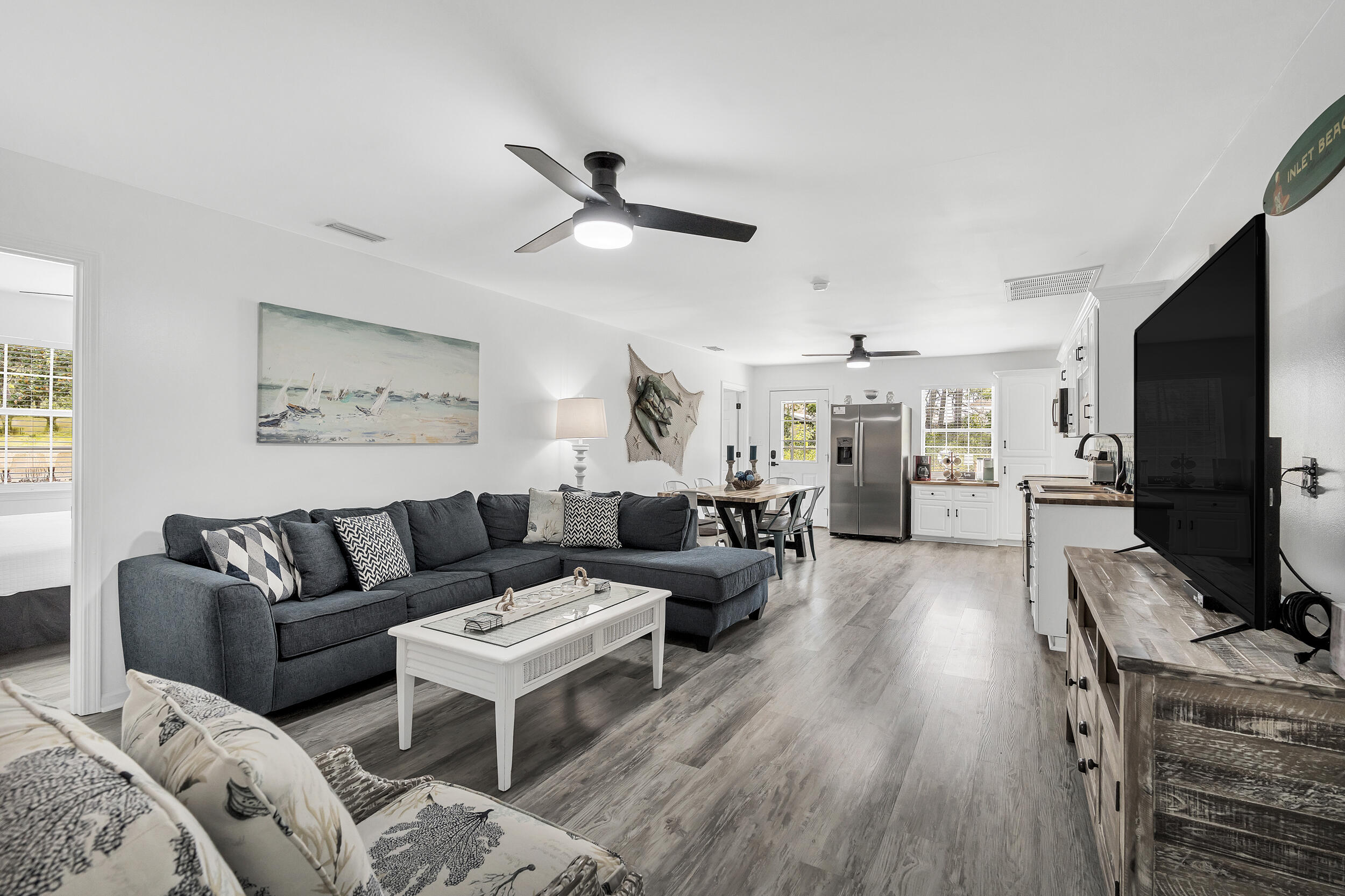 481 North Orange Street Inlet Beach, FL 32461 - Photo 21 of 57 a living room with furniture a ceiling fan and a flat screen tv