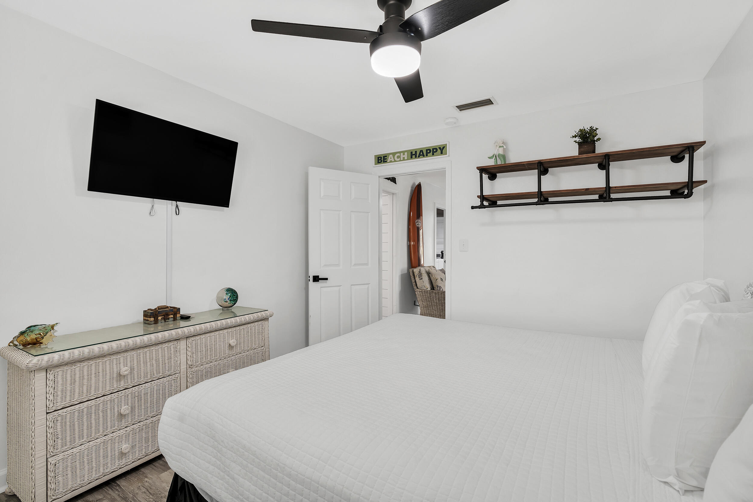481 North Orange Street Inlet Beach, FL 32461 - Photo 24 of 57 a bedroom with a bed and a flat tv screen on the dresser