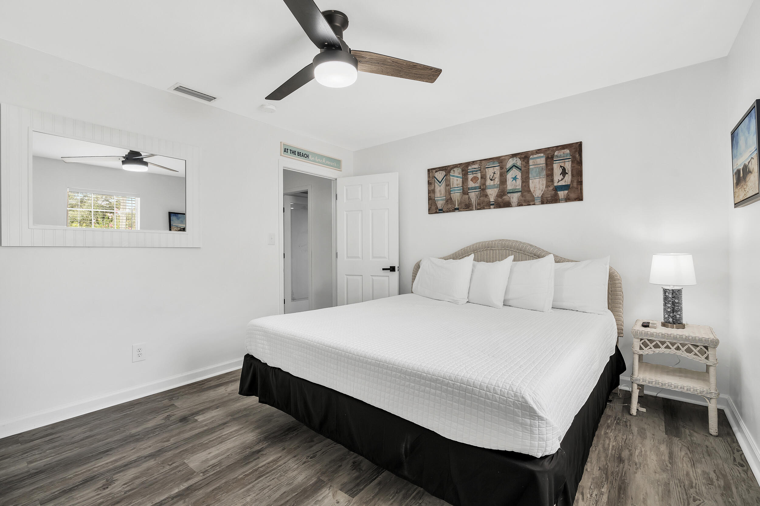 481 North Orange Street Inlet Beach, FL 32461 - Photo 28 of 57 a large bedroom with a bed and wooden floor
