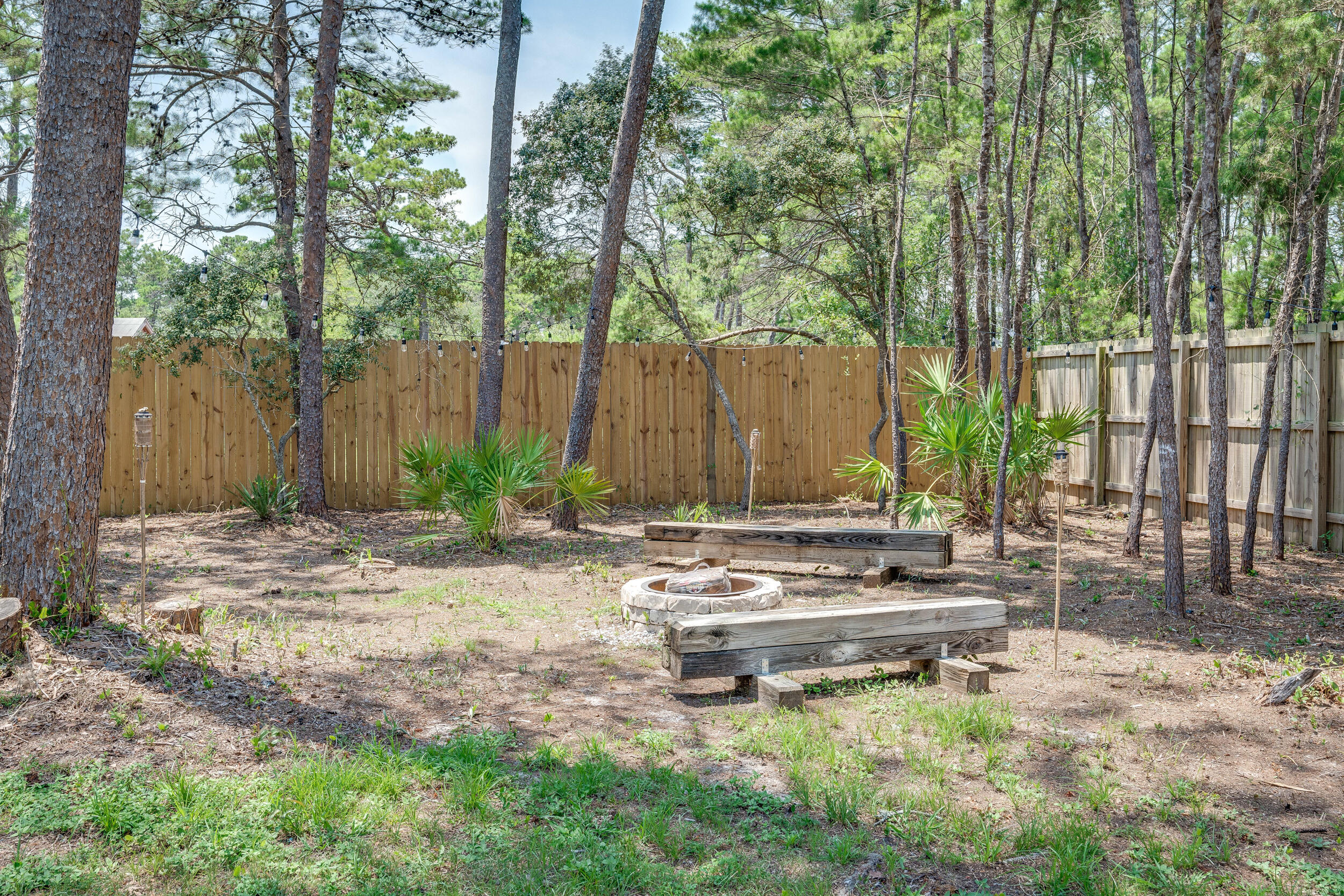 481 North Orange Street Inlet Beach, FL 32461 - Photo 50 of 57 a wooden bench sitting in the middle of a yard