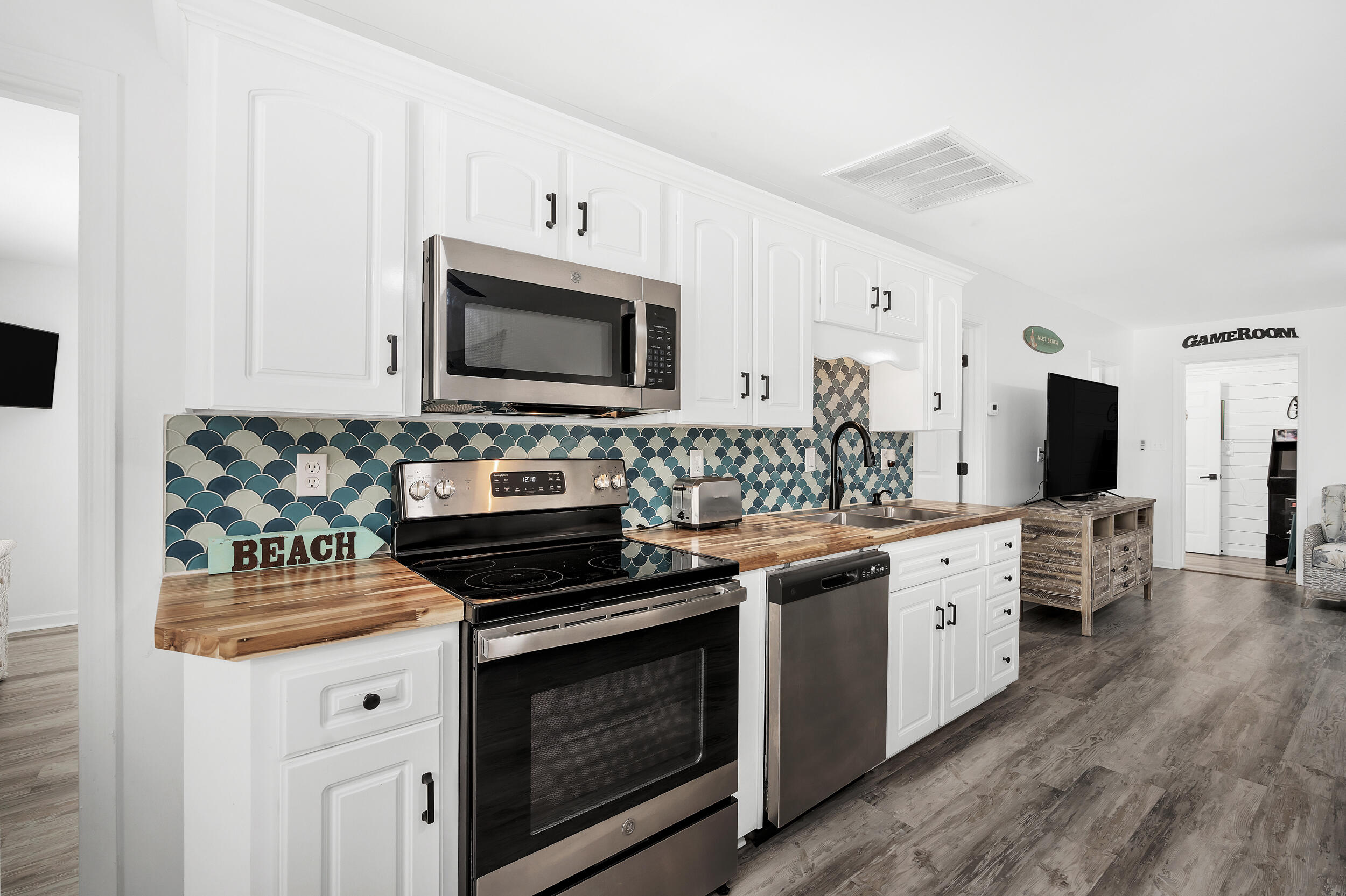 481 North Orange Street Inlet Beach, FL 32461 - Photo 7 of 57 a kitchen with stainless steel appliances a stove microwave and cabinets