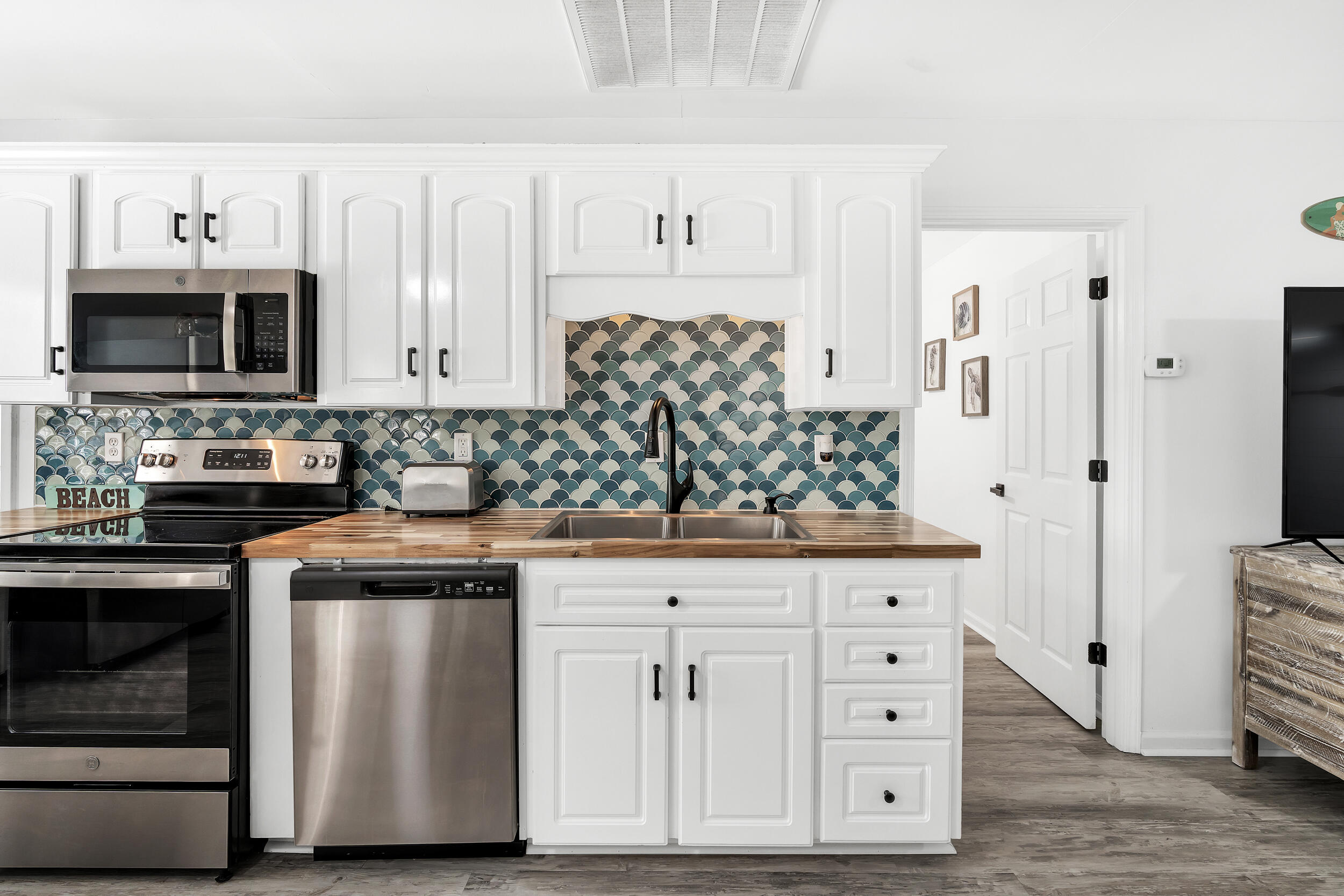 481 North Orange Street Inlet Beach, FL 32461 - Photo 8 of 57 a kitchen with stainless steel appliances granite countertop a stove a microwave and a refrigerator