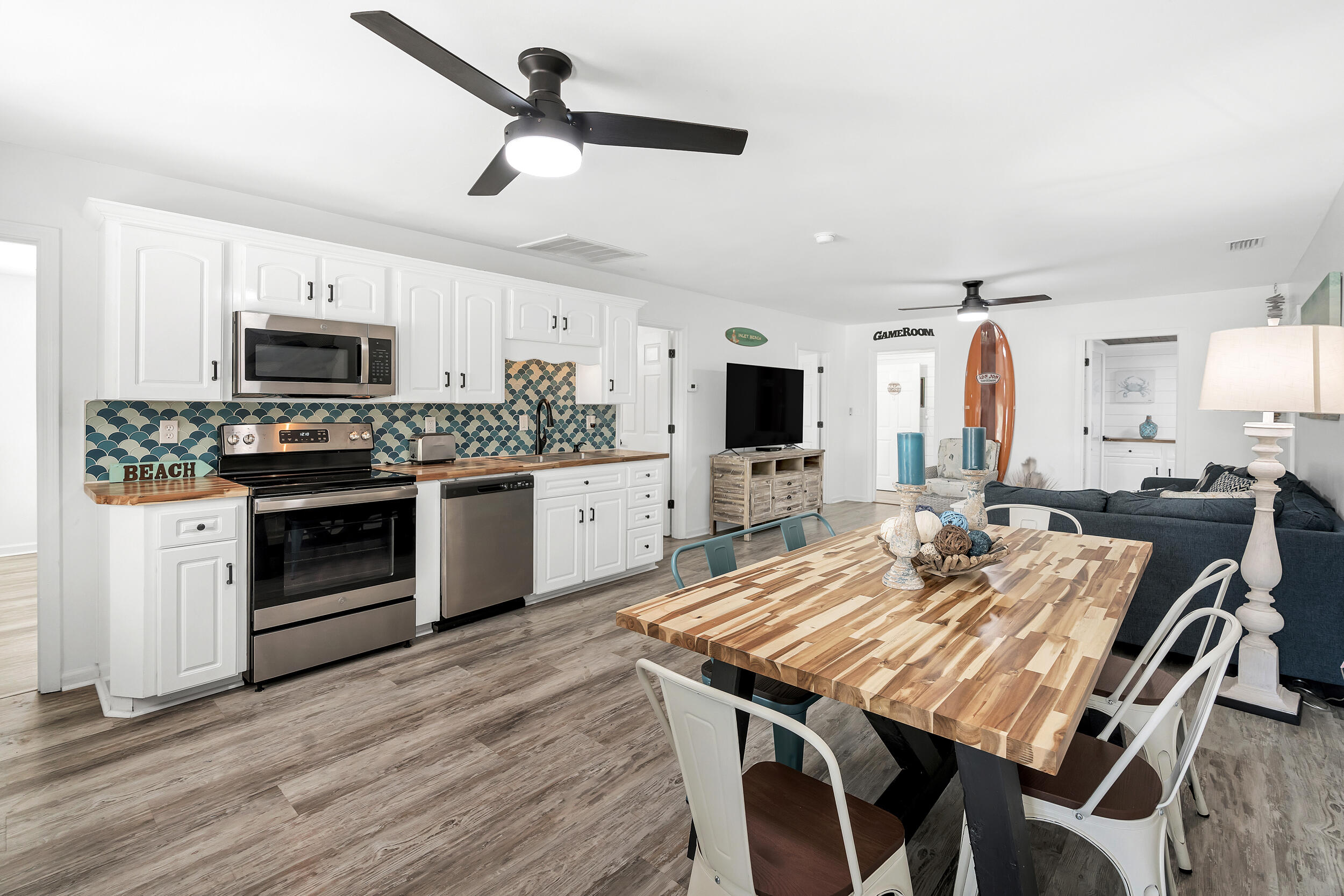 481 North Orange Street Inlet Beach, FL 32461 - Photo 10 of 57 a kitchen with kitchen island a stove a table and chairs in it