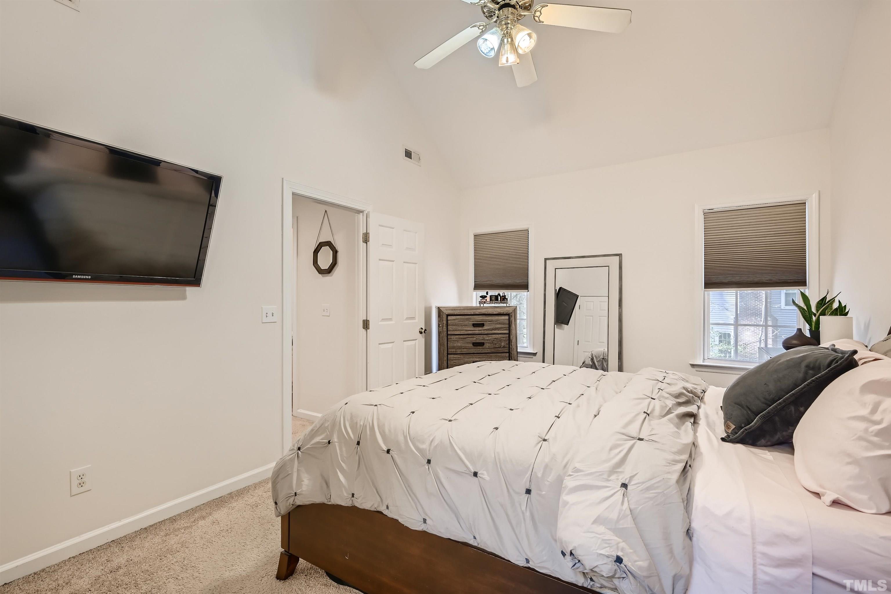 1705 Reynolda Court Raleigh, NC 27603 - Photo 14 of 28 a bedroom with a bed and a flat tv screen on dresser