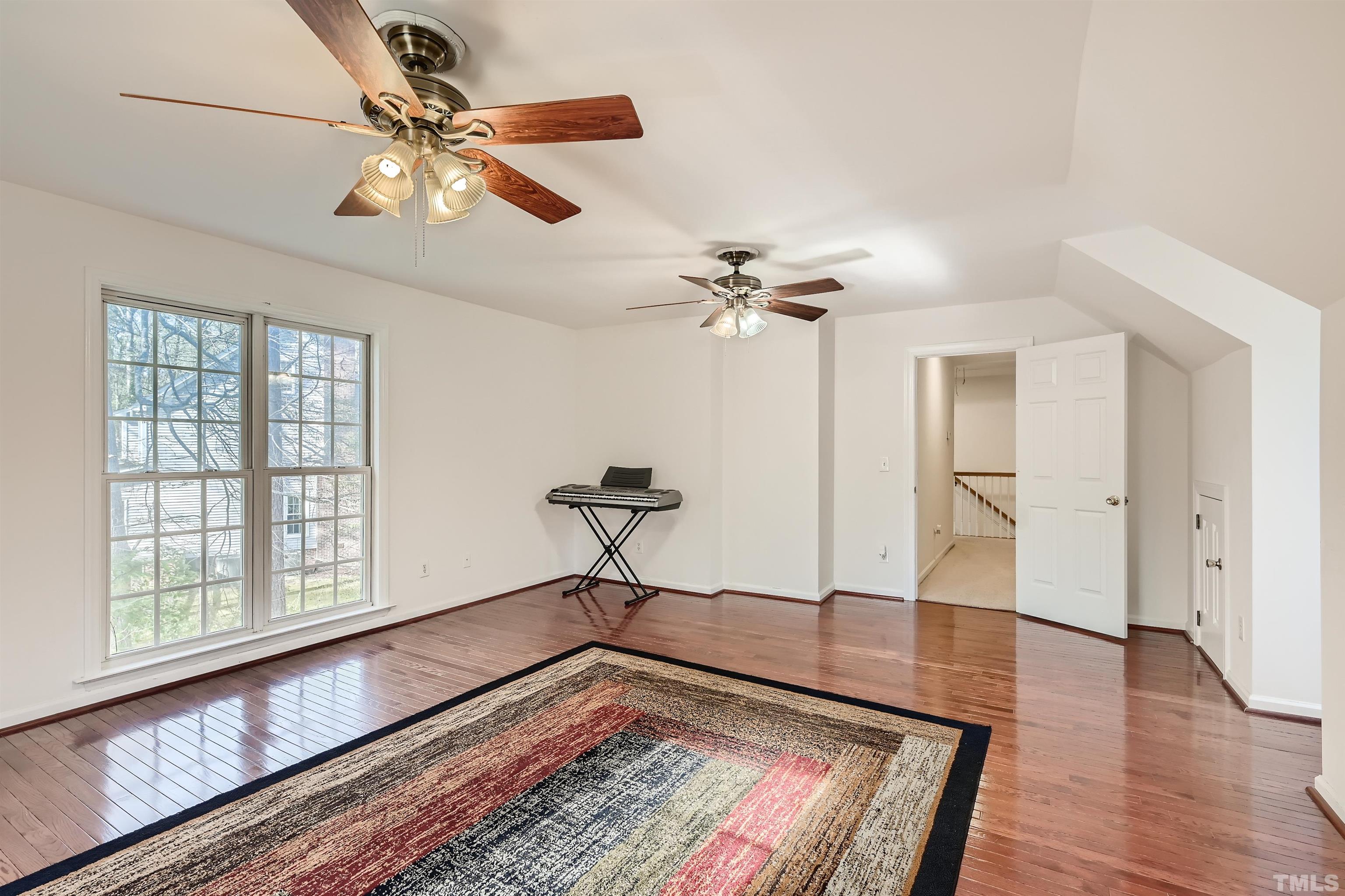 1705 Reynolda Court Raleigh, NC 27603 - Photo 22 of 28 a view of an empty room with wooden floor and a window