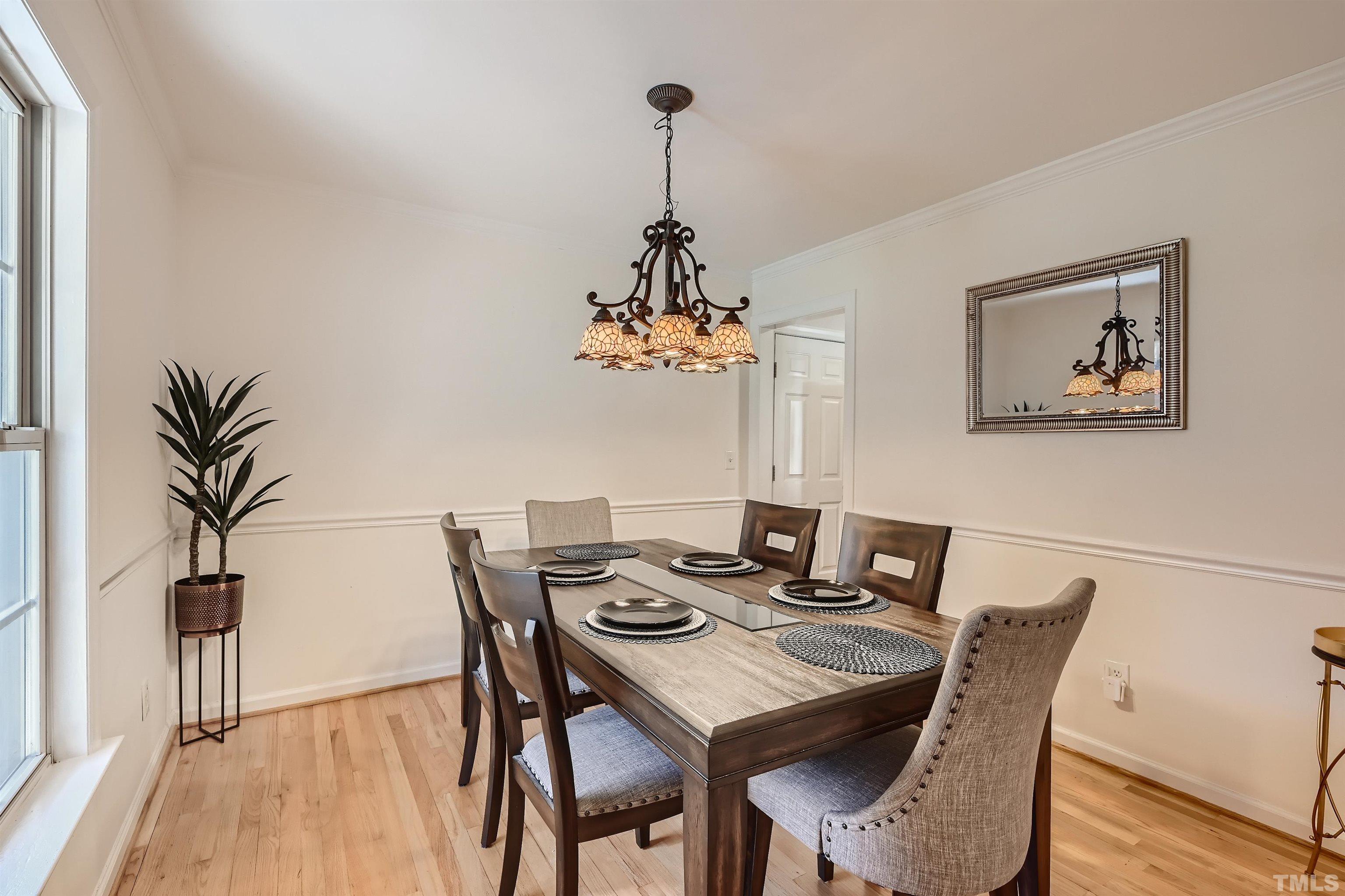 1705 Reynolda Court Raleigh, NC 27603 - Photo 8 of 28 a view of a dining room with furniture wooden floor and a chandelier