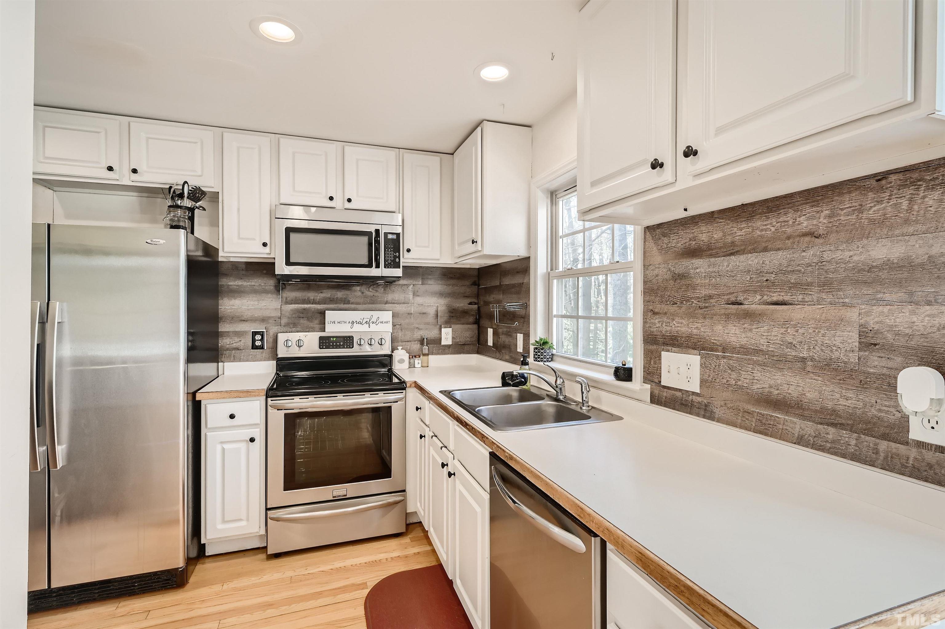 1705 Reynolda Court Raleigh, NC 27603 - Photo 9 of 28 a kitchen with a stove a sink and a refrigerator