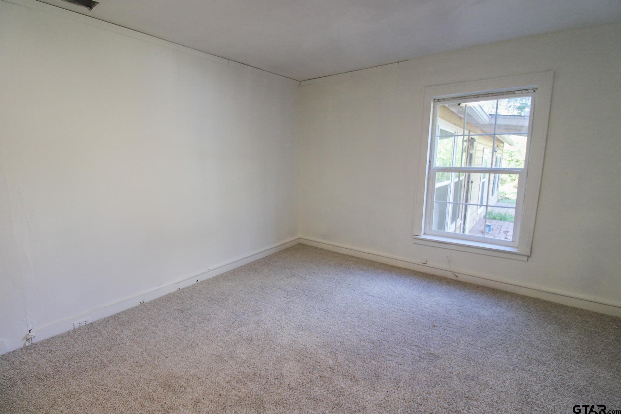 407 Pace Street Naples, TX 75568 - Photo 18 of 31 an empty room with a window