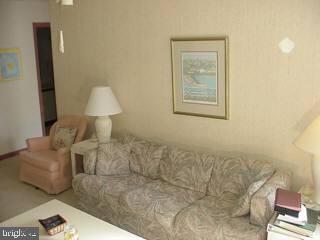 0 Edward Taylor Road, Unit 164 Ocean City, MD 21842 - Photo 3 of 7 a living room with furniture and a lamp