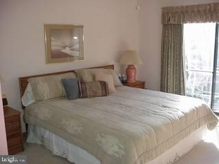 0 Edward Taylor Road, Unit 164 Ocean City, MD 21842 - Photo 4 of 7 a large bed sitting in a bedroom next to a window