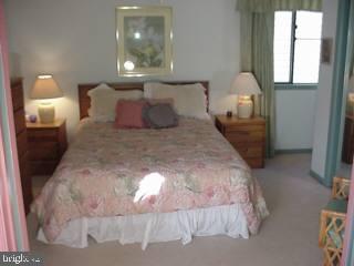 0 Edward Taylor Road, Unit 164 Ocean City, MD 21842 - Photo 7 of 7 a large bed sitting in a bedroom next to a window