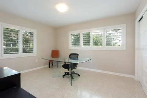 a bathroom with a granite countertop sink mirror vanity and toilet