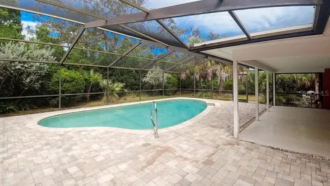a backyard of a house with table and chairs