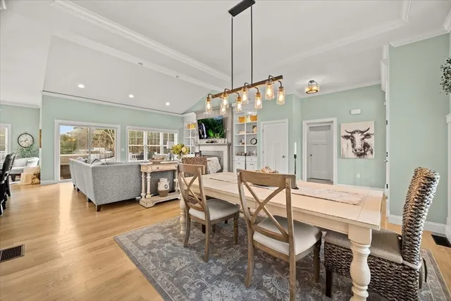 a dining room with furniture and wooden floor