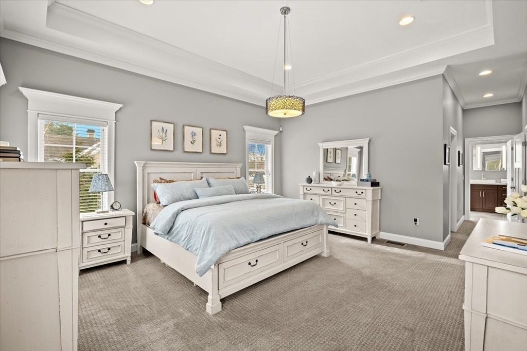 34 Palmer River Road Swansea, MA 02777 - Photo 32 of 42 a spacious bedroom with a bed and a chandelier