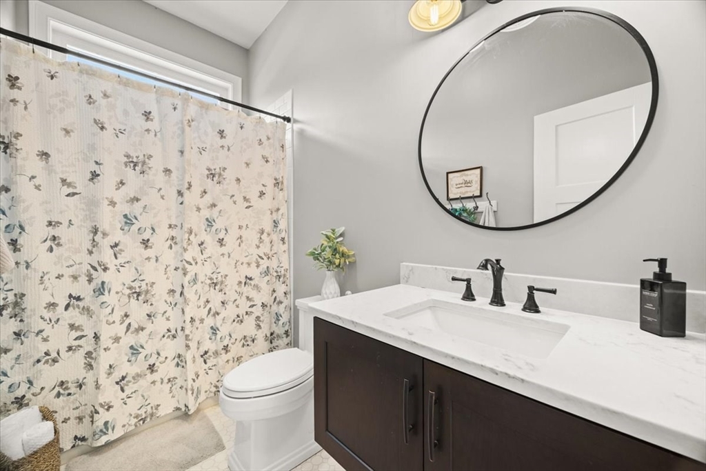 34 Palmer River Road Swansea, MA 02777 - Photo 38 of 42 a bathroom with a sink mirror and toilet