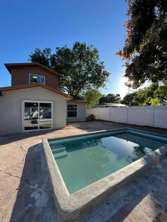 swimming pool view with a seating space