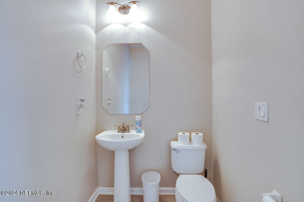 116 Straw Pond Way St. Augustine, FL 32092 - Photo 16 of 63 a bathroom with a toilet sink and mirror