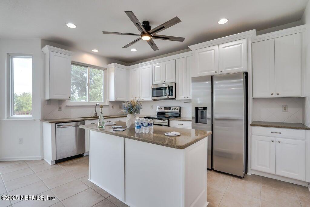 116 Straw Pond Way St. Augustine, FL 32092 - Photo 10 of 63 a kitchen with refrigerator cabinets and a sink