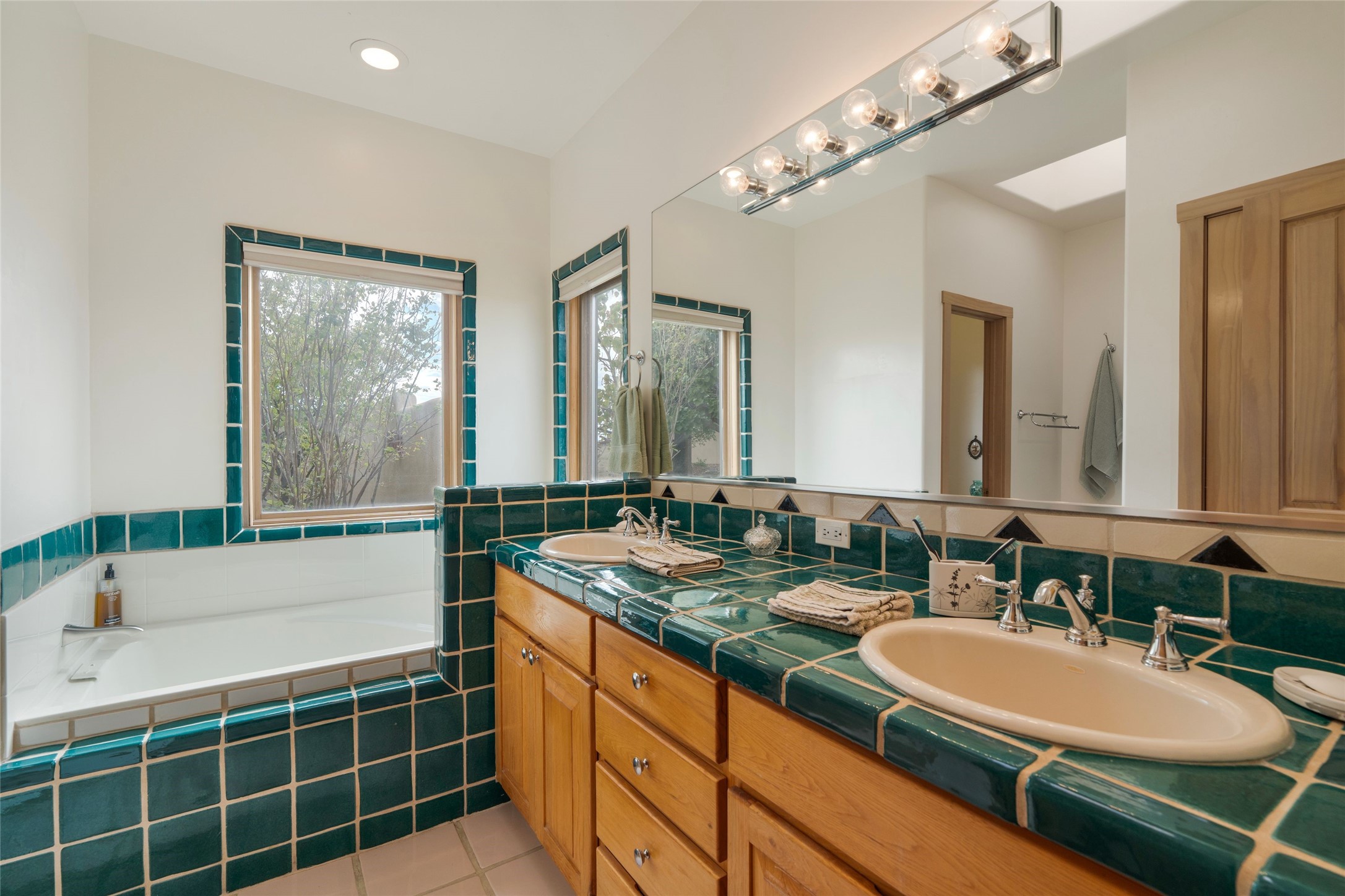23 Descanso Road Santa Fe, NM 87508 - Photo 23 of 54 Owners’ bathroom with tub, shower, and double sinks