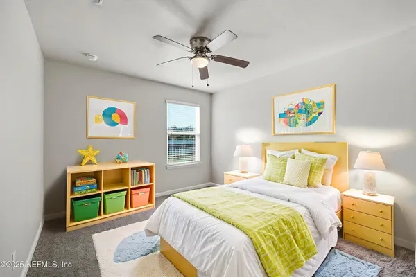 a bedroom with a bed and a wooden floor