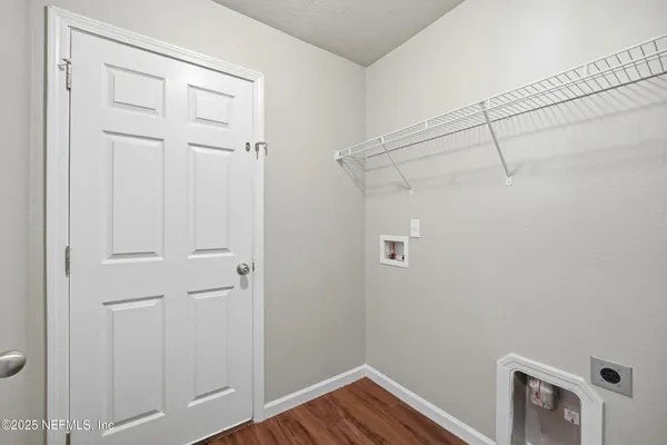a view of a room with wooden floor
