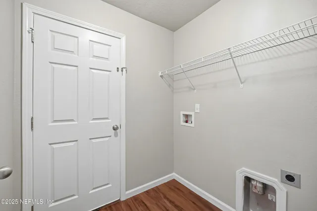 a view of a room with wooden floor