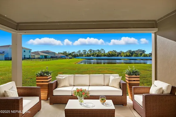 a view of swimming pool with outdoor seating and a ocean view