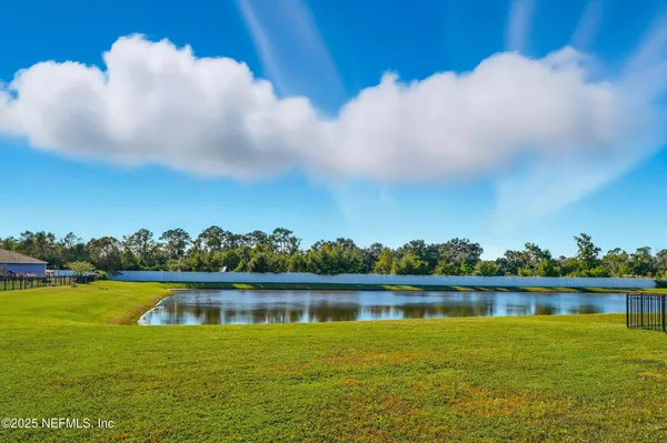a view of a lake with houses in the background